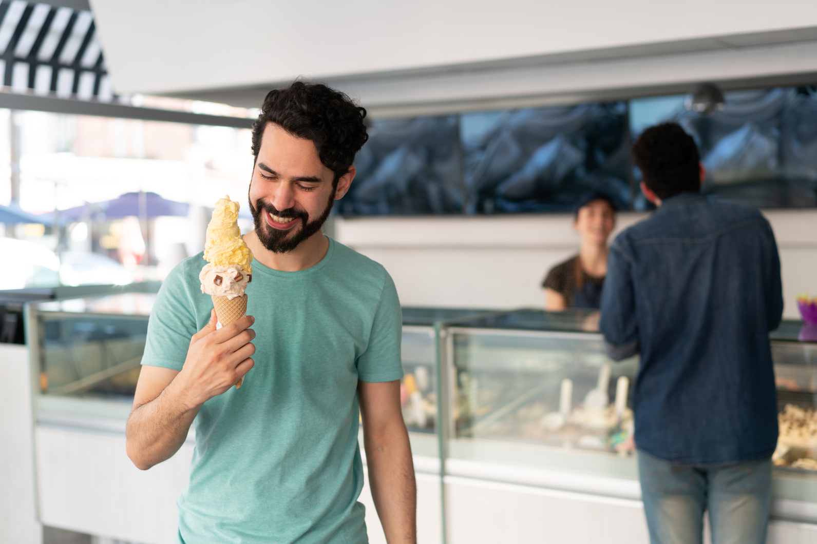 Man eating an ice cream at an ice cream shop